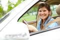 Cant wait to take this for a spin. A pretty young girl sitting behind the wheel of her brand new car. Royalty Free Stock Photo