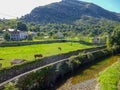 Cantabria landscape with field,grasing horses, mountains and a small village. Spain