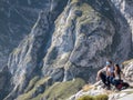 Cantabria, Spain, 5 October 2019 Couple of tourists, hikers resting and admiring mountains in Cantabria, Picos de Europa