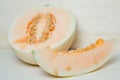 Cantaloupe or Charentais melon with half and seeds on wooden boa