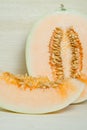 Cantaloupe or Charentais melon with half and seeds on wooden boa