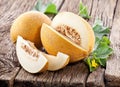 Cantaloupe melon with leaf and melon slice on old wooden table Royalty Free Stock Photo