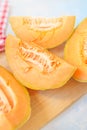Cantaloupe melon slices on rustic wooden table Royalty Free Stock Photo