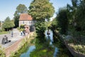 Canterbury, UK - Sep 27th 2020 Tourists enjoy a ride in a punt on the river Stour as it runs past the statue of the Bulkhead by