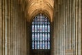 Stained glass window and Gothic architecture columns of the central nave inside the historic Canterbury Cathedral