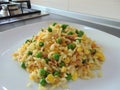 Cantonese rice with curry on a white plate on the kitchen. Close-up, isolated Royalty Free Stock Photo