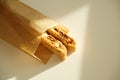 Cantucci cookies with candied fruits and nuts in a paper bag. White background, sunlight Royalty Free Stock Photo