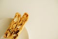 Cantucci cookies with candied fruits and nuts on a white plate. White background, copy space Royalty Free Stock Photo