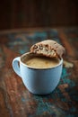 Cantuccini Italian biscuits with a cup of coffee on rustic wooden background.