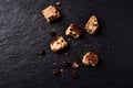 Cantuccini Italian biscuits and roasted coffee beans on dark stone background.