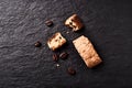 Cantuccini Italian biscuits and roasted coffee beans on dark stone background.