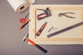 Canvas artist on roll, stretcher for canvas, staple gun and other tools on a gray background Royalty Free Stock Photo