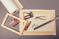 Canvas artist on roll, stretcher for canvas, staple gun and other tools on a gray background Royalty Free Stock Photo