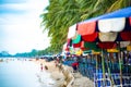 Canvas beds and beach umbrellas await visitors at Bangsaen Beach