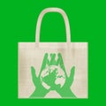 Canvas cotton textiles eco bag. Hands carefully hold the Earth. Natural color. Grunge burlap texture