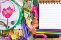 Canvas with embroidered red flower, hoops, threads, pencils, marker and Notepad on wooden table Royalty Free Stock Photo