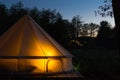 Canvas glamping tent glows at night Royalty Free Stock Photo