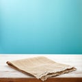 Canvas napkin with lace, tablecloth on wooden table and blue background. Can used for display or montage your products. Selective Royalty Free Stock Photo