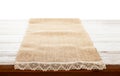 Canvas napkin with lace, tablecloth on wooden table on white background. Can used for display or montage your products