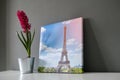 Canvas print stretched on frame with gallery wrap on grey wall background. Photography with Paris Eiffel Tower