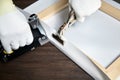 Canvas stretching. Wooden stretcher bar, staple gun, canvas pliers, male hand in white protect gloves Royalty Free Stock Photo