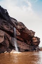 Canyon cliff shoreline and waterfall of Mekong river and local fisherman boat at Ban Pha Chan, Ubon Ratchathani - Thailand