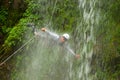 Canyoning Tour Leader Jumping Into A Waterfall Royalty Free Stock Photo