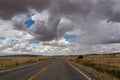 Canyonland - Long empty highway travels through desert of American Southwest near near Moab, Utah, USA Royalty Free Stock Photo
