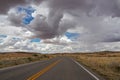 Canyonland - Long empty highway travels through desert of American Southwest near near Moab, Utah, USA Royalty Free Stock Photo