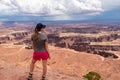 Canyonlands - Woman with scenic view on Split Mountain Canyon seen from Grand View Point Overlook near Moab, Utah, USA Royalty Free Stock Photo