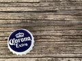 Rockford,WI/USA.- Feb 12, 2019: Cap of Corona Extra beer close up on wooden table. Corona is the most popular imported beer in the