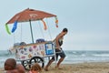 CAP D`AGDE, FRANCE - JULY 30, 2016:A man pulls a cart with ice cream on the beach