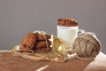 Cap of milk with oat cookies and decore. Homemade food. On Black background with back light