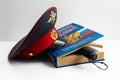 The cap of a Russian police officer and a rubber baton is on the code of laws. Isolate. Royalty Free Stock Photo