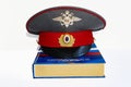 The cap of a Russian police officer and a rubber baton is on the code of laws. Isolate. Royalty Free Stock Photo