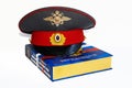 The cap of a Russian police officer and a rubber baton is on the code of laws. Isolate. Royalty Free Stock Photo