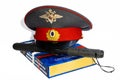 The cap of a Russian police officer and a rubber baton is on the code of laws. Isolate. Royalty Free Stock Photo