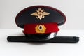 The cap of a Russian police officer and a rubber baton is on the code of laws. Isolate. Royalty Free Stock Photo