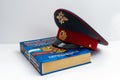 The cap of a Russian police officer and a rubber baton is on the code of laws. Isolate. Royalty Free Stock Photo