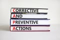 CAPA synbol. Concept words `CAPA, corrective and preventive actions` on books on a beautiful white background. Business and CAPA