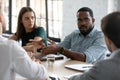 Black male consultant persuading group of clients in deal profit Royalty Free Stock Photo