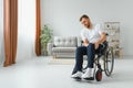 Capable disabled trying to get up from the wheelchair Royalty Free Stock Photo
