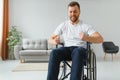 Capable disabled trying to get up from the wheelchair. Royalty Free Stock Photo