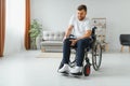Capable disabled trying to get up from the wheelchair. Royalty Free Stock Photo