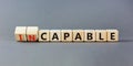 Capable or incapable symbol. Concept words Capable or Incapable on wooden cubes. Beautiful grey table grey background. Business