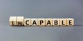 Capable or incapable symbol. Concept words Capable or Incapable on wooden cubes. Beautiful grey table grey background. Business