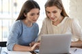 Capable pleasant female bank consultant assisting young woman client