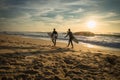 Capbreton, France - October 4, 2017: enthusiastic surfers going for surf session in scenic beautiful sunset seascape