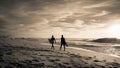 Capbreton, France - October 4, 2017: enthusiastic surfers going for surf session in scenic beautiful sunset seascape