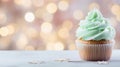 Capcake decorated with pastel green cream on a beautiful winter blurred bokeh background. Christmas dessert food on the table